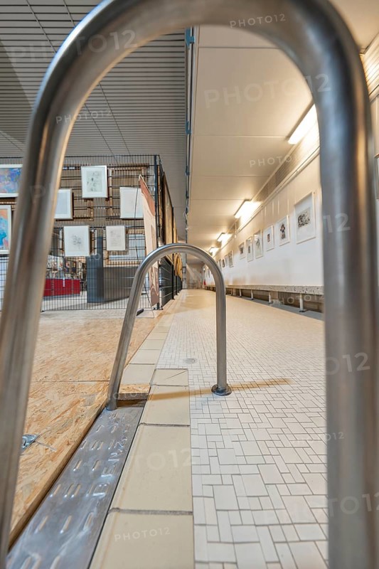 Railing in a gallery corridor with tiled floor and illuminated walls, historical art exhibition in the old swimming pool, Schaudepot, Calw, Black Forest, Germany