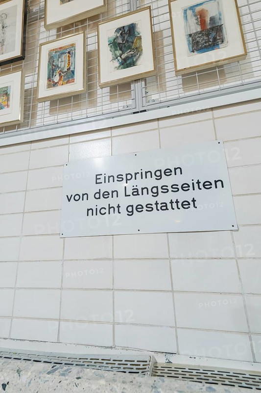 Sign on a tiled wall in a gallery with works of art on display, historical art exhibition in the old swimming pool, Schaudepot, Calw, Black Forest, Germany