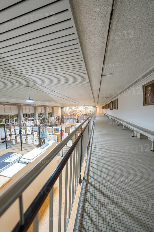 A corridor on the upper floor with a view of a large art gallery decorated with various works, historical art exhibition in the old swimming pool, Schaudepot, Calw, Black Forest, Germany