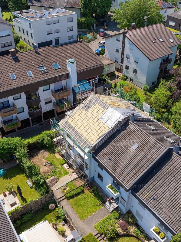 Viewed from above, houses with a partially renovated roof in a green neighbourhood, roof renovation, house construction, Pforzheim, Germany