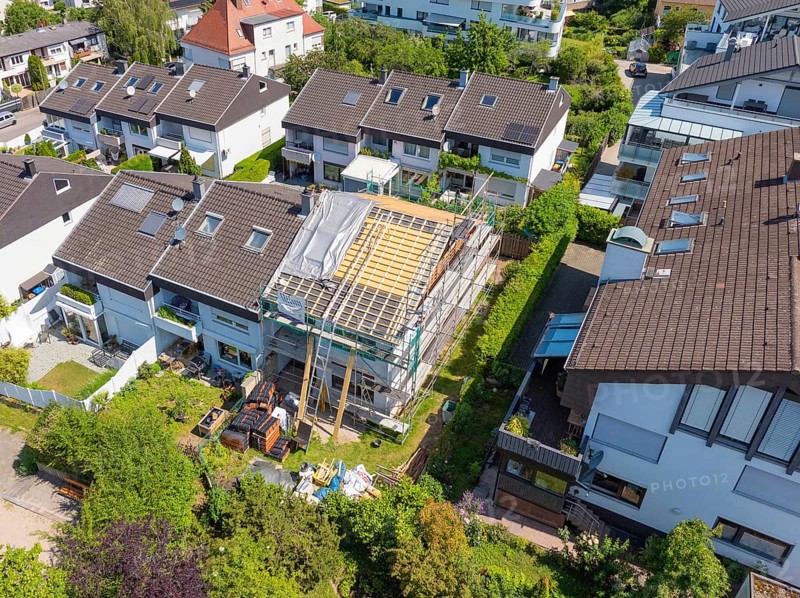 View over a residential area. A roof under renovation, surrounded by other houses, roof renovation, house construction, Pforzheim, Germany