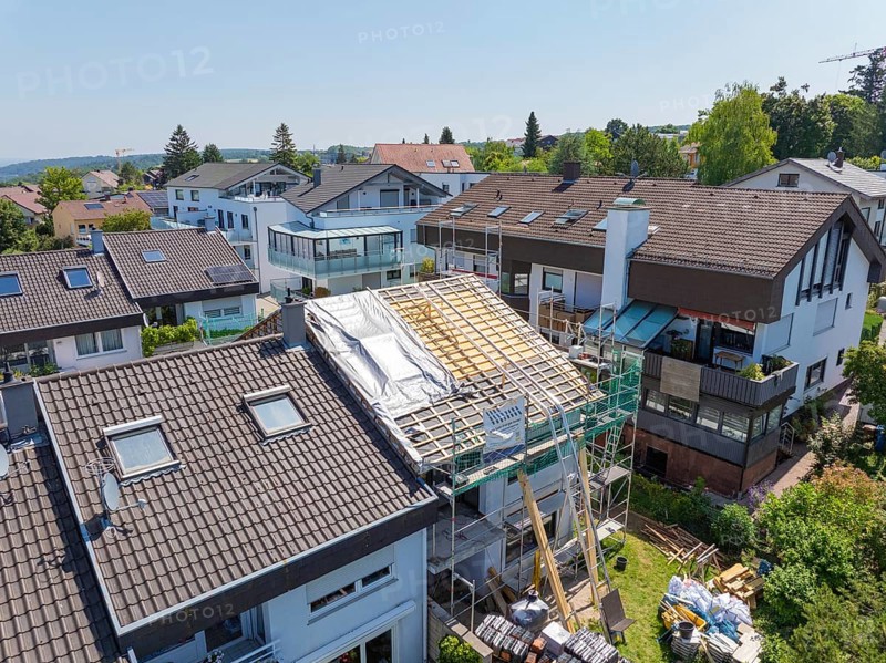 House with scaffolding and partially open roof in a suburban residential area, roof renovation, house construction, Pforzheim, Germany