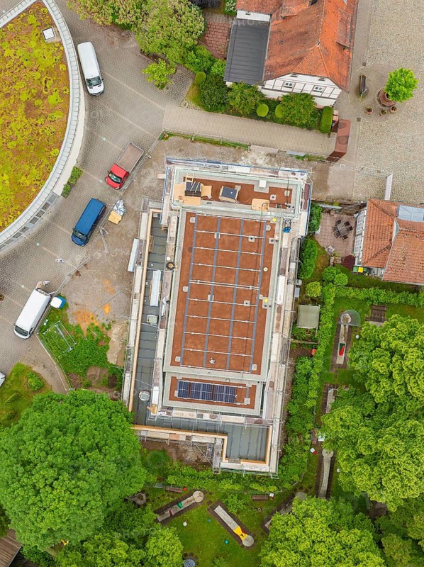 Building with visible roof in the construction phase, surrounded by vehicles and trees, Hirsau, Calw, Germany