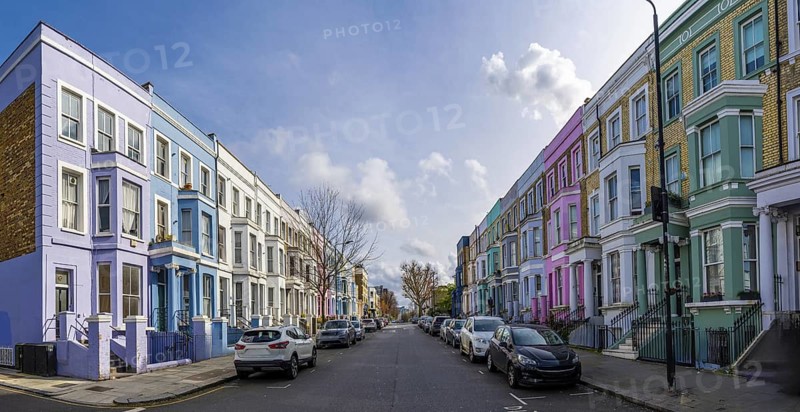 Traditional colorful terraced houses lining a street in notting hill, a popular neighborhood in london, uk, known for its vibrant atmosphere