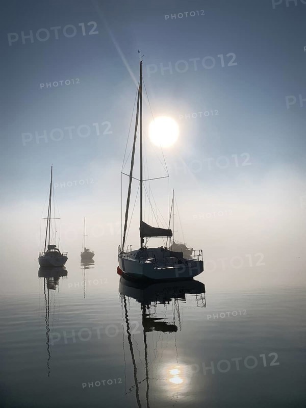 Evening atmosphere, sailing boats on Lake Starnberg near fog, Bavaria, Germany