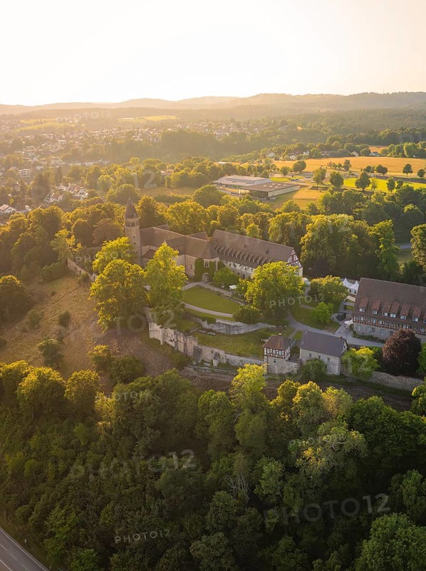 Aerial view of a monastery surrounded by dense vegetation at sunset, event and wedding location Lorch Monastery, Lorch, Germany