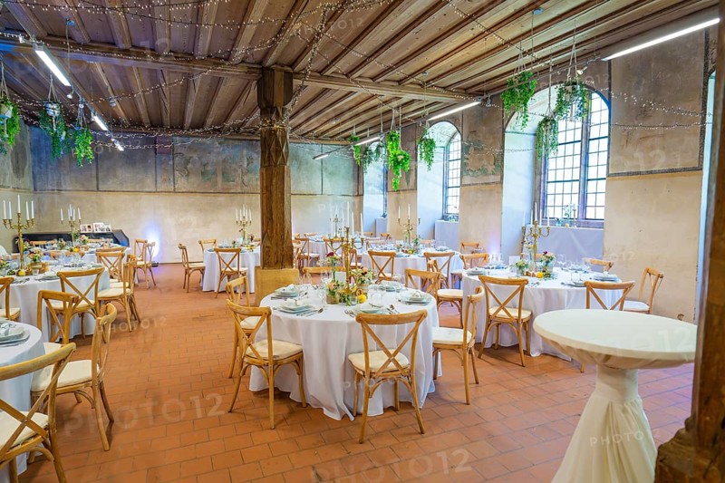 Rustic wedding setting with round tables and natural lighting through windows, event and wedding location Lorch Monastery, Lorch, Germany