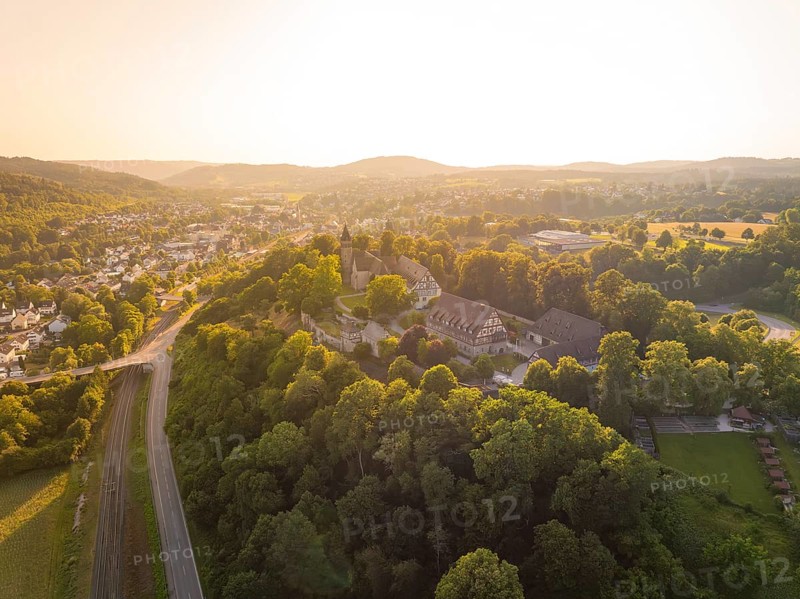 A village on a hill surrounded by forest and half-timbered houses at dusk, event and wedding location Lorch Monastery, Lorch, Germany