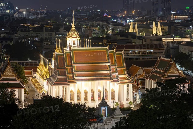 Panorama after sunset from Golden Mount to Wat Ratchanatdaram Worawihan and the Democracy Monument in the background on the right, skyline of Bangkok, Thailand