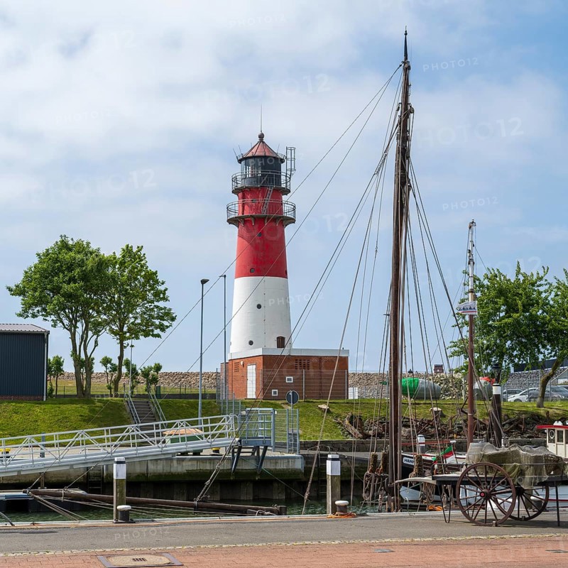 Lighthouse, sailing boat in the foreground, Büsum, North Sea, Schleswig-Holstein, Germany