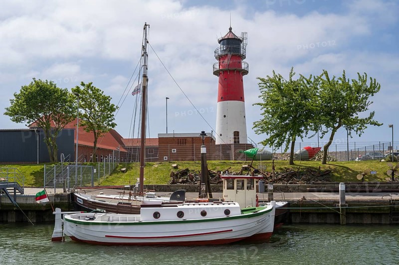 Sailing ship at the harbour, behind lighthouse, Büsum, North Sea, Schleswig-Holstein, Germany