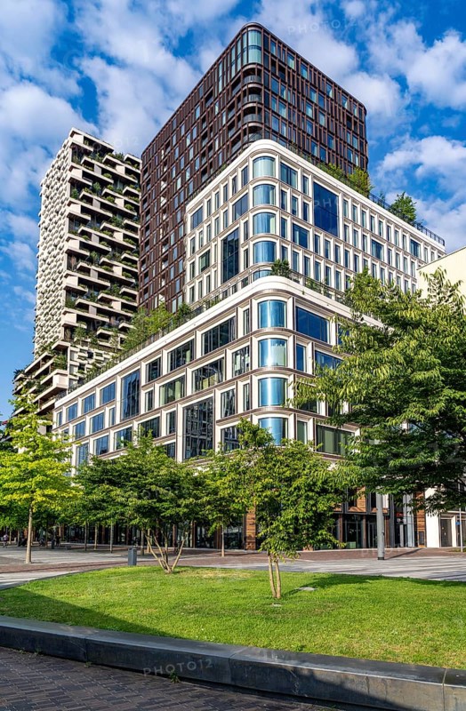 Residential tower Wonderwoods, 2 green buildings, in Utrecht in the new Healthy Urban Quarter, at the Central Station, 105 metres high with 30 floors, Tower II, rear, Tower I, front, 70 metres high, over 360 trees and over 9600 shrubs and flowering plants native to the region, all irrigated with collected rainwater, sponge city principle and monitored with sensors, Utrecht, Netherlands