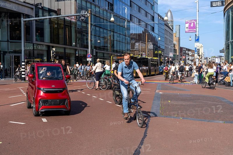 Central cycle path along the Vredenburg, in the city centre of Utrecht, lanes for pedestrians, cyclists and local traffic are separated, heavy traffic, no car/truck traffic, mini car, moped car, Utrecht, Netherlands