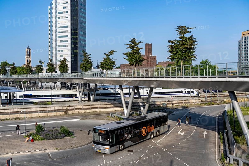 The Moreelsebrug, pedestrian and cyclist bridge over the tracks of Utrecht Centraal, Central Station, Greened with trees, ICE of the German Federal Railway on the way from Amsterdam to Germany Netherlands