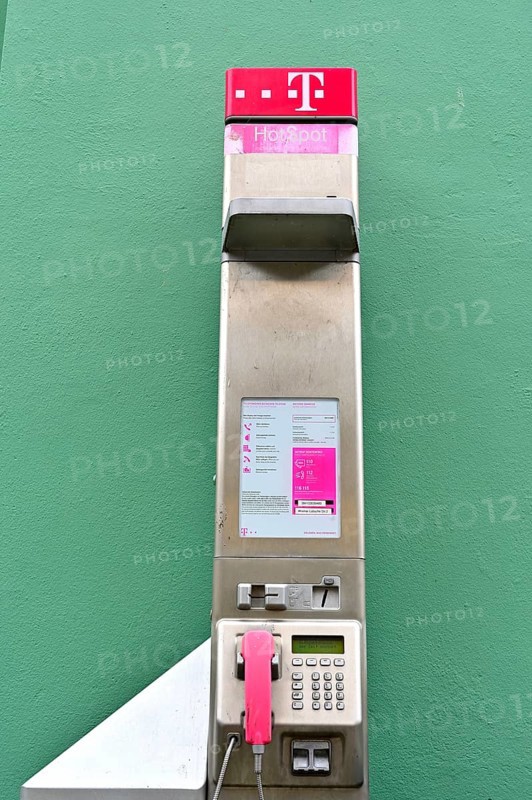 Public telephone on a green wall, Wismar, Mecklenburg-Vorpommern, Germany