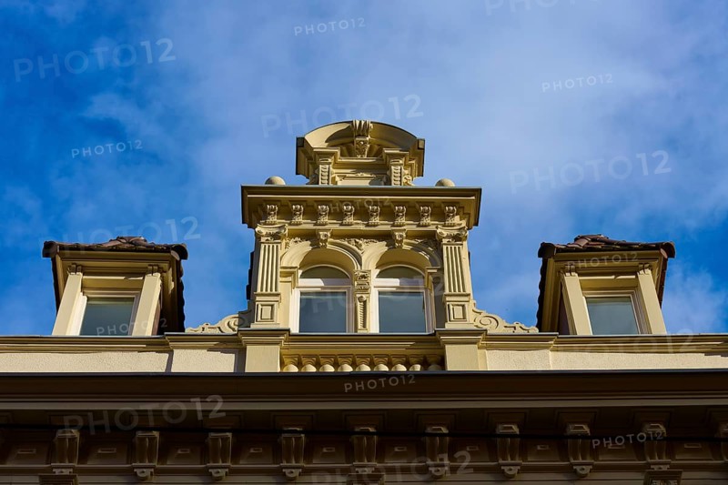 Decorative façade of a historic building with windows and baroque details under a blue sky, Freiburg im Breisgau, Black Forest, Baden-Württemberg, Germany