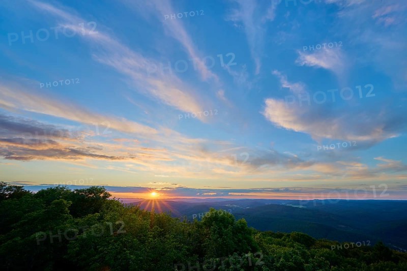 Sunset with soft colours in the sky over wooded area, Katzenbuckel, Waldbrunn, Neckar-Odenwald-Kreis, Odenwald, Baden-Württemberg, Germany
