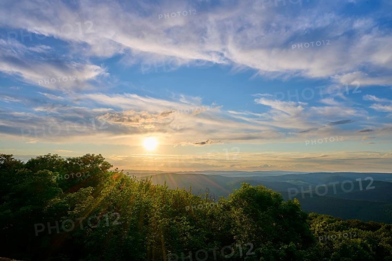 Sunset over wooded landscape with picturesque clouds, Katzenbuckel, Waldbrunn, Neckar-Odenwald-Kreis, Odenwald, Baden-Württemberg, Germany