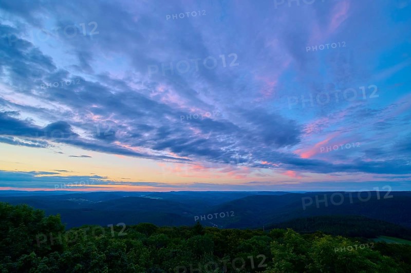 Purple and pink clouds fill the night sky over a forest landscape, twilight, Katzenbuckel, Waldbrunn, Neckar-Odenwald-Kreis, Odenwald, Baden-Württemberg, Germany