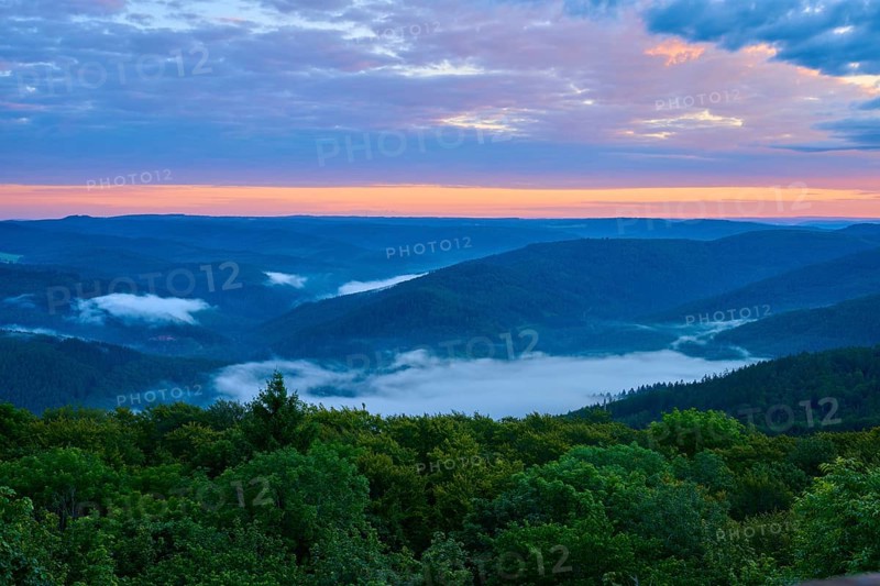 Hilly landscape at dusk, fog in the valleys, orange-blue sky, Katzenbuckel, Waldbrunn, Neckar-Odenwald-Kreis, Odenwald, Baden-Württemberg, Germany