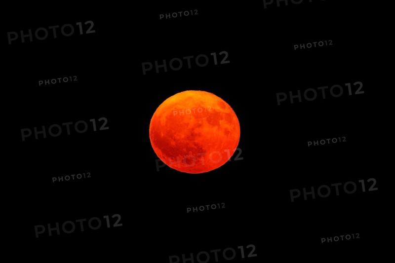 Bright red full moon in the dark sky, full moon, strawberry moon 2025, Vosges, France