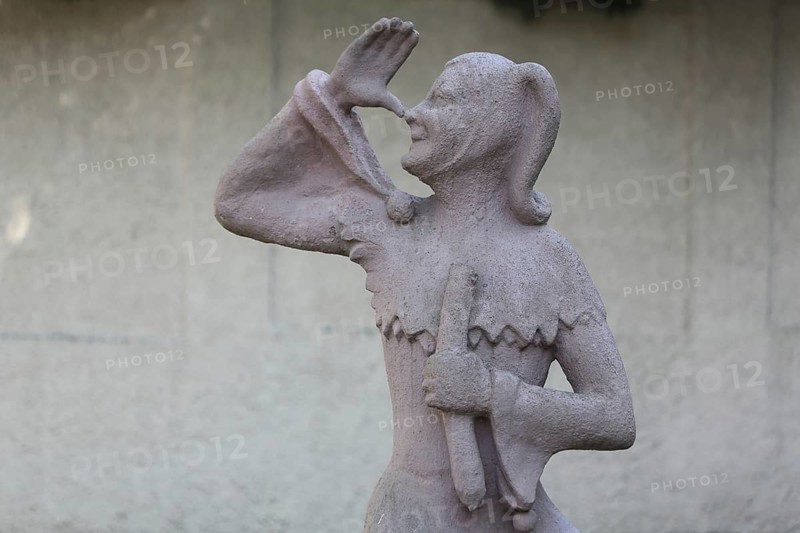 Sculpture of Till Eulenspiegel with gesture, thumb on nose, arm, high, up, hand, Bernburg, Saxony-Anhalt, Germany