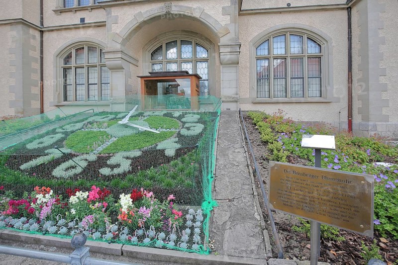 Flower clock made of blooming flower-bed with flower bed, clock face, garden art, information board with text, inscription, town hall, Bernburg, Saxony-Anhalt, Germany