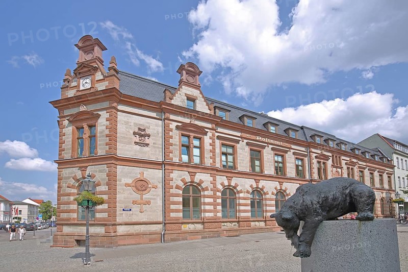 Historic post office and post office fountain with bear figure catching fish, sculpture, fountain, Bernburg, Saxony-Anhalt, Germany