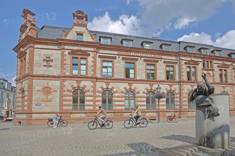 Historic post office and post office fountain with sculpture symbolising the Silent Post, fountain, cyclist, Bernburg, Saxony-Anhalt, Germany
