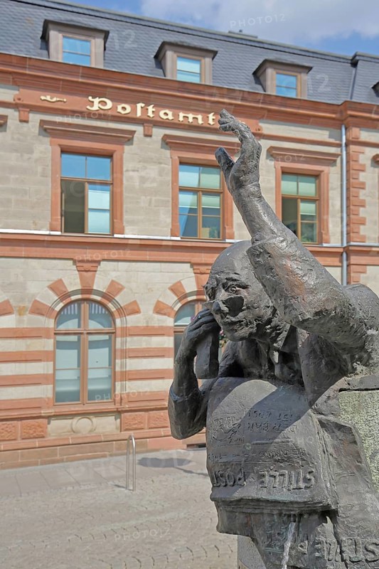 Postal fountain with sculpture symbolising silent mail, inscription, telephoning, gesture, arm, high, above, post office, Bernburg, Saxony-Anhalt, Germany