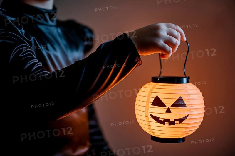Girl in witch black costume holding glowing pumpkin lantern. generative ai, AI generated