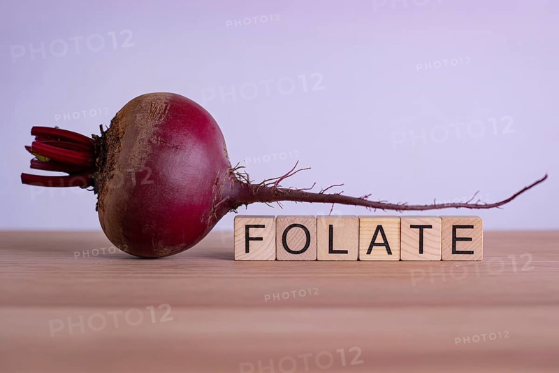 Crimson beetroot with wooden blocks spelling Folate. Generative ai, AI generated