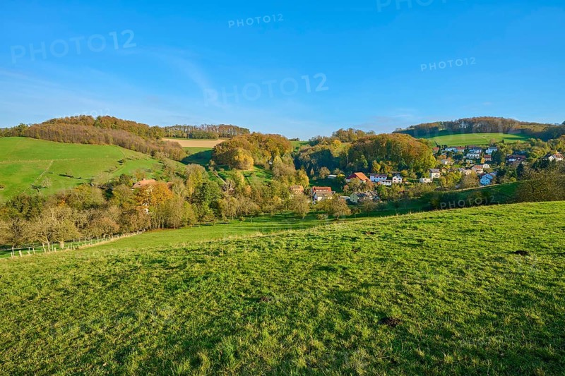 Small village embedded in green hills and trees, creating a harmonious landscape, Vöckelsbach, Mörlenbach, Bergstrasse district, Odenwald, Hesse, Germany