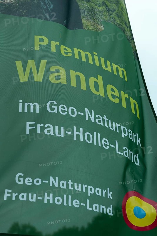 Premium hiking trail, GEO nature park Park Frau Holle Land am Meissner, low mountain range, legendary figure, home of the fairy tale, inscription on flag Kassel district, Fulda Werra Bergland, Germany