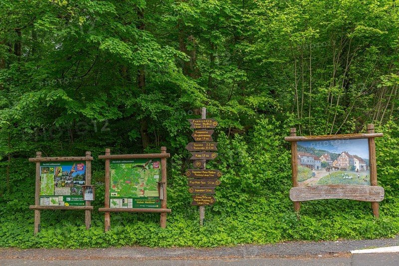 Signposts with directions for hiking trails and premium trails, GEO nature park Park Frau Holle Land am Meissner, low mountain range, legendary figure, home of the fairy tale, maps for orientation, painting of the mining village of Schwalbenthal from 1880, Kassel district, Fulda Werra Bergland, Germany