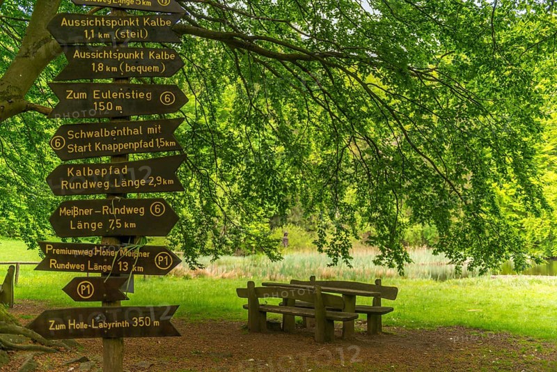 Frau Holle pond in the GEO nature park Park Frau Holle Land am Meissner, seating area, signpost for the premium hiking trails, low mountain range, legendary figure, home of the fairy tale, forest reed bank, Kassel district, Fulda Werra Bergland, Germany