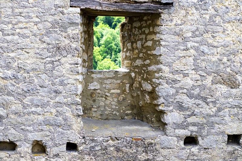Stone window of the Reußenstein castle ruins with a view of the surrounding nature, Neidlingen