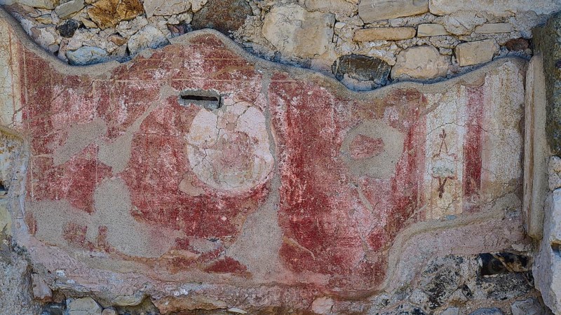 Decorated ancient wall fragment with red elements and traces of weathering, Archaeological Site, House of Beluga (sturgeon), Western Excavation, Kos Town, Kos, Dodecanese, Greek Islands, Greece