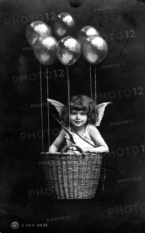 Cupid floating in basket with balloons, girl as angel in basket with balloons and wings, imaginative depiction, historical photo