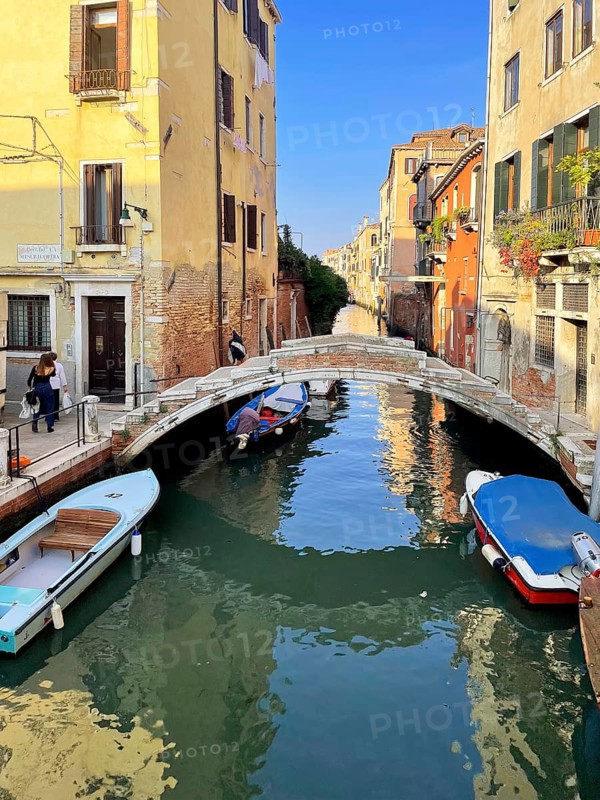 Boats and gondolas on a canal in Venice, lagoon city of Venice, Veneto, Italy
