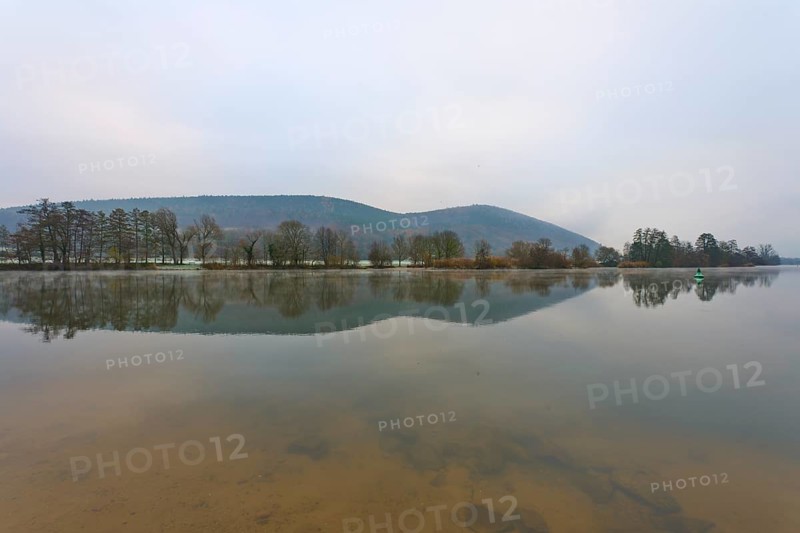Wide river with calm water surface, mountains in the background, cloudy sky, Laudenbach, Main, Spessart, Odenwald, Bavaria Germany