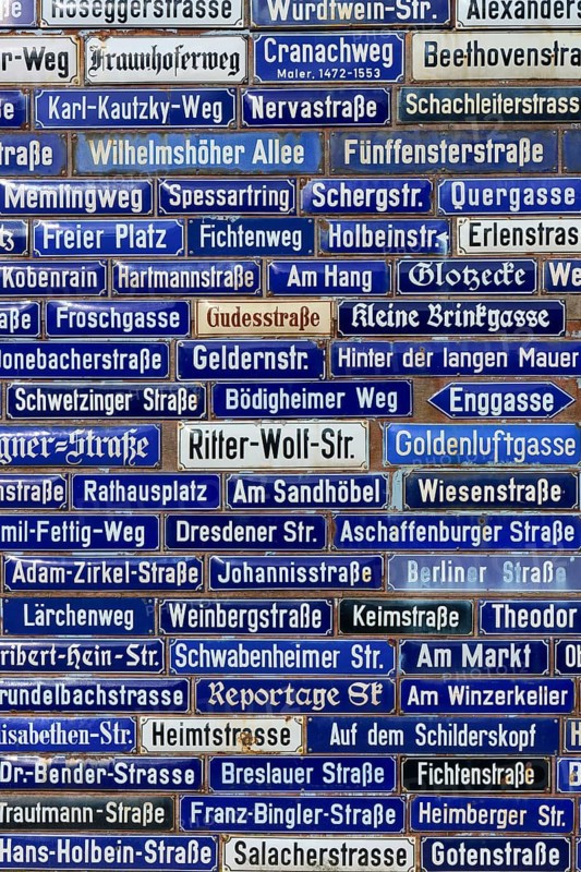 Compact collection of blue street signs with numerous street names, Amorbach, Odenwald, Bavaria, Germany