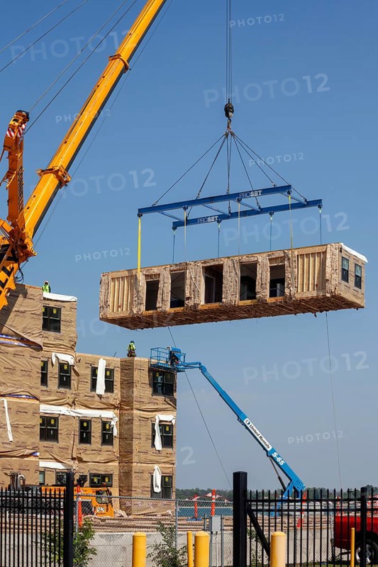 Detroit, Michigan - Workers use modular construction methods to build apartments for low to moderate income households. Each module is put together off site by Ginosko Modular