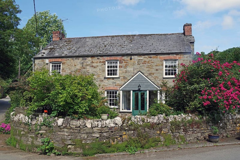 Stone house with lush garden and blooming flowers under a blue sky, idyllic cottage, Cornwall, Cornwall, England, United Kingdom