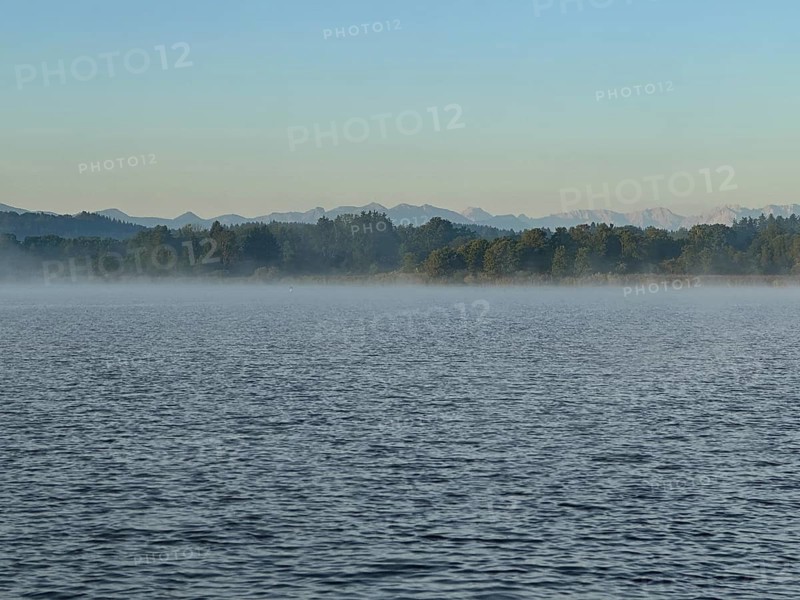 Light fog over Lake Starnberg with a view of the Alps, Bavaria, Germany