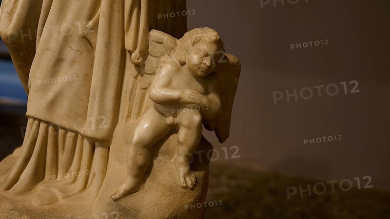 Marble sculpture of a small angel as part of a larger statue, carved in classical style, Archaeological Museum, Kos Town, Kos, Dodecanese, Greek Islands, Greece