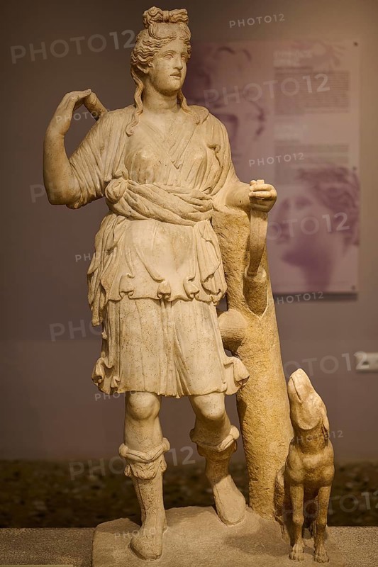 Ancient sculpture of Artemis with dog, in classical traditional costume and pose, Archaeological Museum, Kos Town, Kos, Dodecanese, Greek Islands, Greece