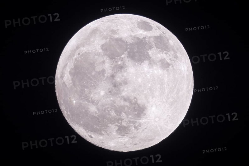 Full moon shining bright in the night sky, shining silver in a clear dark winter night, detailed view of the supermoon over North Rhine-Westphalia Germany, Europe Full moon, fullmoon is shining bright, silver light, close, clear dark winter night, looks close, supermoon, detailed view, January, 2019