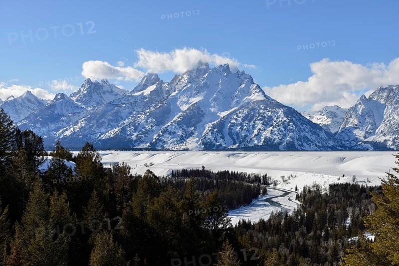 View over the Snake River... Teton Range (Rocky Mountains) in winter with snow, down in the valley the river winds like a snake, behind it the high mountains rise steeply, famous landscape in North America