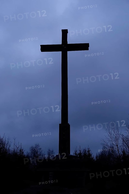 Cross against the dark sky, summit cross in the dark, mystical atmosphere of an approaching thunderstorm, bad weather, Schiebergkreuz in Balve, Sauerland, Germany